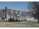Charming two-story home with dormer windows, a brick chimney, and a well-manicured lawn at 8510 Polaris Dr, Bahama, NC 27503