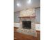 Close-up of a stunning stone fireplace with a wooden mantel, creating a cozy focal point in the living space at 8510 Polaris Dr, Bahama, NC 27503