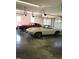 Large garage with a concrete floor featuring two vintage cars and three garage doors at 8510 Polaris Dr, Bahama, NC 27503