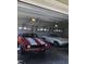 Three-car garage with a concrete floor featuring two classic cars and three garage doors at 8510 Polaris Dr, Bahama, NC 27503