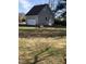 Side view of a detached garage with a white door and light-colored siding at 8510 Polaris Dr, Bahama, NC 27503