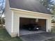 Garage with a single-car bay and a classic car parked inside on a concrete floor at 8510 Polaris Dr, Bahama, NC 27503