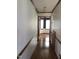 Hallway featuring hardwood floors and wooden trim at 8510 Polaris Dr, Bahama, NC 27503