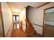 Interior hallway with hardwood floors, staircase, wood trim, and lots of natural light at 8510 Polaris Dr, Bahama, NC 27503