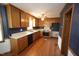 Traditional kitchen featuring wooden cabinets, laminate countertops, and hardwood flooring at 8510 Polaris Dr, Bahama, NC 27503