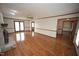 Spacious living room with hardwood floors, stone fireplace, and view to the dining room at 8510 Polaris Dr, Bahama, NC 27503
