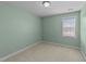 Bright bedroom featuring neutral carpet and a window for natural light at 8712 New River Cir, Raleigh, NC 27603