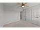 Spacious bedroom featuring neutral carpet, ceiling fan, and ample closet space at 8712 New River Cir, Raleigh, NC 27603