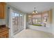 Bright breakfast nook features a window seat, chandelier, and access to the deck at 8712 New River Cir, Raleigh, NC 27603