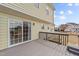 View of the deck, with sliding glass doors and gray wooden rails, steps, and floor at 8712 New River Cir, Raleigh, NC 27603