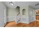 Welcoming foyer showcasing hardwood floors, staircase, and decorative wall niche at 8712 New River Cir, Raleigh, NC 27603