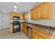 Kitchen features wooden cabinets, stainless steel appliances, and ample counter space at 8712 New River Cir, Raleigh, NC 27603
