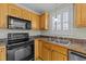 Kitchen features stainless steel appliances, a built-in microwave, and double sink at 8712 New River Cir, Raleigh, NC 27603