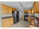 Kitchen with wooden cabinets, recessed lighting, and modern appliances at 8712 New River Cir, Raleigh, NC 27603