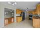 Functional kitchen with wood cabinets, black appliances, and tile floors at 8712 New River Cir, Raleigh, NC 27603