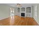 Cozy living room with hardwood floors, built-in shelves, and a fireplace at 8712 New River Cir, Raleigh, NC 27603
