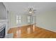 Bright living room featuring hardwood floors, a fireplace and plantation shutters at 8712 New River Cir, Raleigh, NC 27603