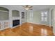Comfortable living room featuring a fireplace with built-in shelving and hardwood floors at 8712 New River Cir, Raleigh, NC 27603