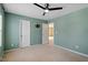 Bedroom with carpet, ceiling fan, and two entry doors at 904 Churchill Glen Blvd, Knightdale, NC 27545