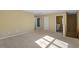 A carpeted bonus room area featuring neutral walls and two doors at 904 Churchill Glen Blvd, Knightdale, NC 27545