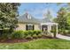 Charming clubhouse with a green roof, dormers, manicured landscaping, and a welcoming entrance at 904 Churchill Glen Blvd, Knightdale, NC 27545