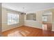 Well lit dining room featuring hardwood floors, a modern chandelier, and neutral wall paint color at 904 Churchill Glen Blvd, Knightdale, NC 27545