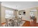Bright dining room featuring hardwood floors, a modern chandelier, and neutral wall paint color at 904 Churchill Glen Blvd, Knightdale, NC 27545