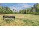 Expansive community green space with a park bench, perfect for relaxing and enjoying the outdoors at 904 Churchill Glen Blvd, Knightdale, NC 27545