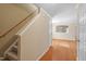 A staircase and hallway featuring neutral walls and hardwood floors at 904 Churchill Glen Blvd, Knightdale, NC 27545