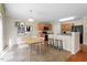 Open kitchen with wooden cabinets, granite countertops, and black appliances with breakfast bar and chairs at 904 Churchill Glen Blvd, Knightdale, NC 27545