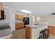 Kitchen features an island with a sink, granite countertops, and wooden cabinetry with black appliances at 904 Churchill Glen Blvd, Knightdale, NC 27545