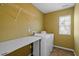 Functional laundry room with washer, dryer, and folding table, complemented by tile flooring at 904 Churchill Glen Blvd, Knightdale, NC 27545