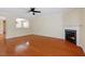 Large, open living room with hardwood floors, a fireplace, and an open partition wall to dining room at 904 Churchill Glen Blvd, Knightdale, NC 27545
