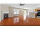 Open living room features hardwood floors, a cozy fireplace, and a connecting door to the kitchen at 904 Churchill Glen Blvd, Knightdale, NC 27545