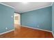 A spacious living room features hard wood flooring and blue walls at 904 Churchill Glen Blvd, Knightdale, NC 27545