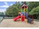 Colorful playground structure with slides and climbing features, set in a safe, mulched area at 904 Churchill Glen Blvd, Knightdale, NC 27545