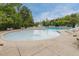 Large community pool with ample seating, surrounded by lush trees for a resort-like feel at 904 Churchill Glen Blvd, Knightdale, NC 27545