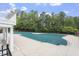 A covered community pool with a concrete surround and a view of mature trees at 904 Churchill Glen Blvd, Knightdale, NC 27545