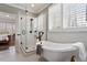 Luxurious bathroom showcasing a freestanding tub, glass-enclosed shower, and elegant finishes at 907 Vintage Hill Pkwy, Durham, NC 27712