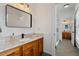 Well-lit bathroom features wood cabinets, white granite, and modern black fixtures at 907 Vintage Hill Pkwy, Durham, NC 27712