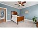 Comfortable bedroom with blue walls, soft carpet, and decorative lighting at 907 Vintage Hill Pkwy, Durham, NC 27712