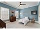 Well-lit bedroom boasts neutral carpet, blue painted walls, and bright, natural light at 907 Vintage Hill Pkwy, Durham, NC 27712