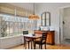 Bright breakfast nook featuring large windows and a charming chandelier at 907 Vintage Hill Pkwy, Durham, NC 27712