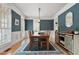 Elegant dining room with wainscoting, hardwood floors, and a stylish light fixture at 907 Vintage Hill Pkwy, Durham, NC 27712