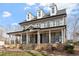 Beautiful two-story home with a welcoming front porch, stone accents, and manicured landscaping at 907 Vintage Hill Pkwy, Durham, NC 27712