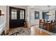 Elegant foyer showcasing hardwood floors, detailed trim, and a sophisticated dining area at 907 Vintage Hill Pkwy, Durham, NC 27712