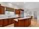 Spacious kitchen featuring custom cabinets, an island with a cooktop, and stainless steel appliances at 907 Vintage Hill Pkwy, Durham, NC 27712