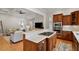 Gourmet kitchen featuring granite countertops, stainless steel appliances, and a gas cooktop island at 907 Vintage Hill Pkwy, Durham, NC 27712