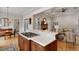 Gourmet kitchen featuring a center island with cooktop, marble counters, and stainless steel appliances at 907 Vintage Hill Pkwy, Durham, NC 27712
