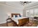 Bright main bedroom features tray ceiling, plantation shutters, and hardwood flooring with decorative area rug at 907 Vintage Hill Pkwy, Durham, NC 27712